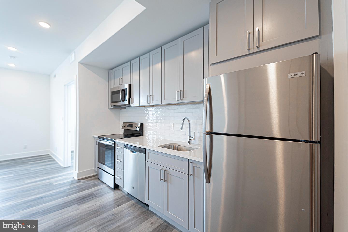 1245 Ridge Avenue, Unit 309 Philadelphia, PA 19123 - Photo 7 of 21 a white refrigerator freezer sitting inside of a kitchen