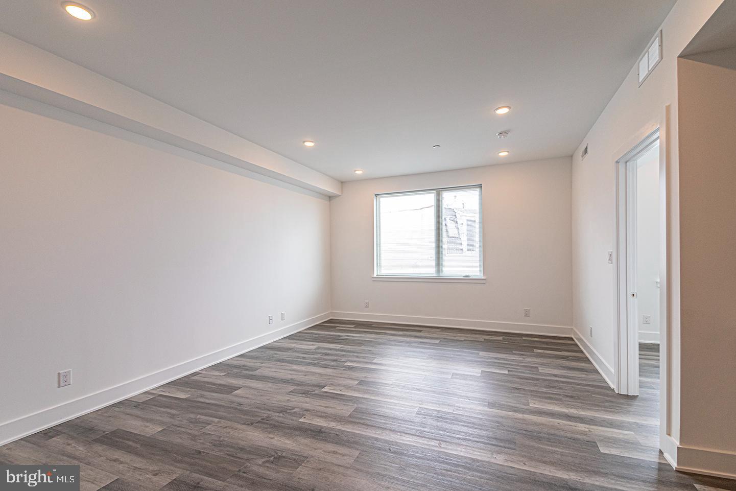 1245 Ridge Avenue, Unit 309 Philadelphia, PA 19123 - Photo 9 of 21 wooden floor in an empty room with a window