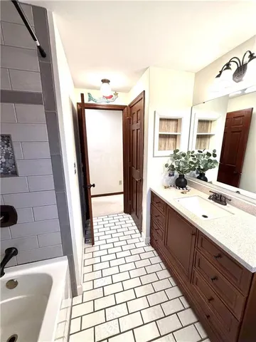 a bathroom with a double vanity sink a toilet a mirror and shower
