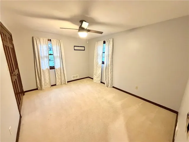 an empty room with windows and entrance