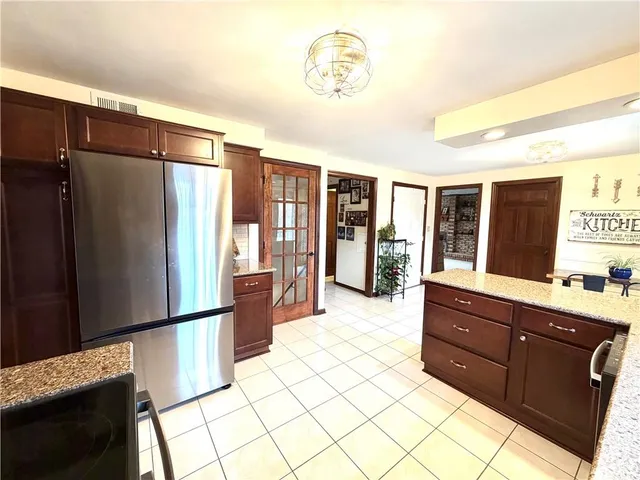 a spacious bathroom with a granite countertop sink mirror and a shower