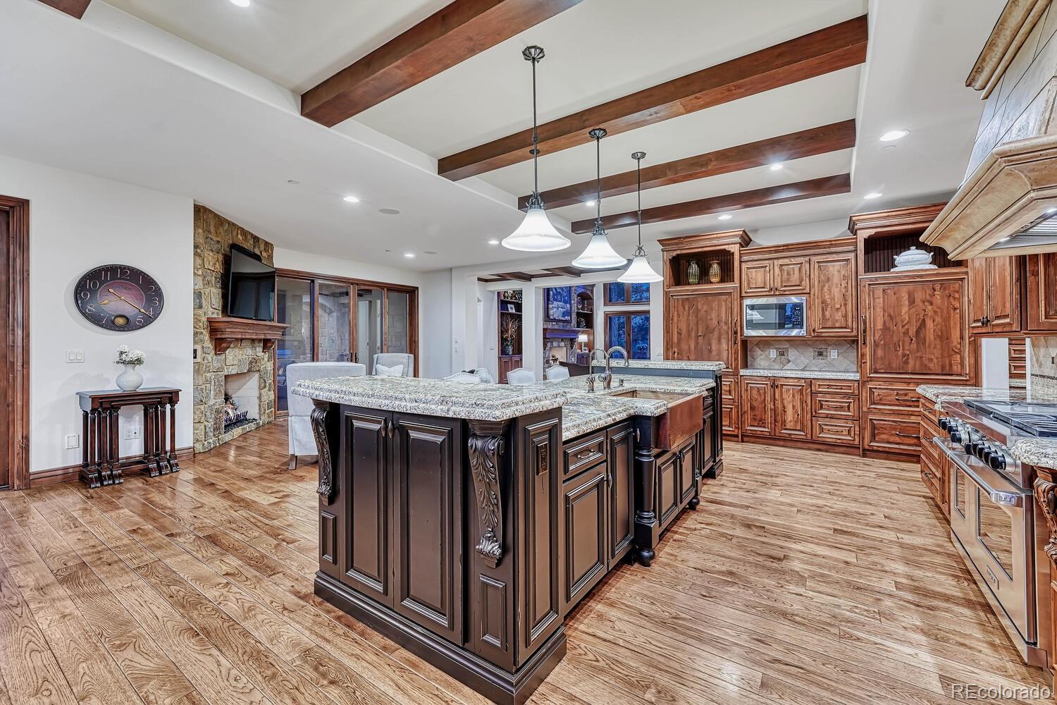 7959 Forest Keep Circle Parker, CO 80134 - Photo 11 of 40 a kitchen with stainless steel appliances granite countertop a large stove a sink dishwasher and cabinets with wooden floor