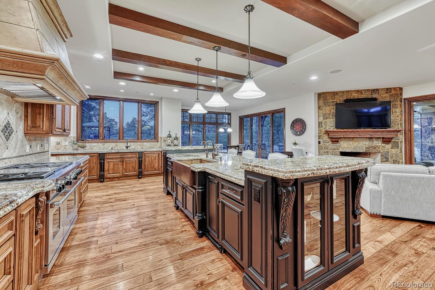 7959 Forest Keep Circle Parker, CO 80134 - Photo 12 of 40 a kitchen with stainless steel appliances granite countertop a stove and a wooden floors
