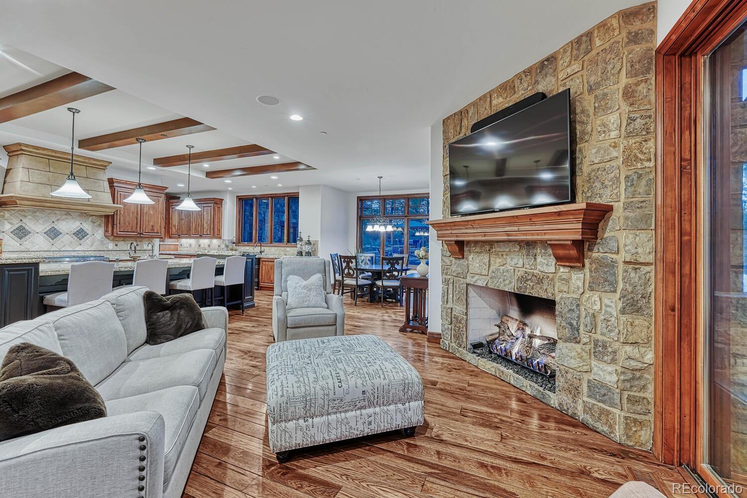 7959 Forest Keep Circle Parker, CO 80134 - Photo 14 of 40 a living room with furniture a flat screen tv and a fireplace