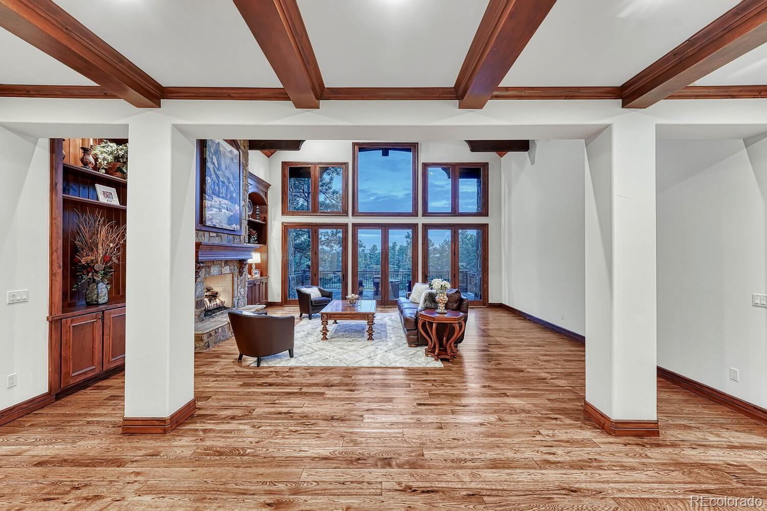 7959 Forest Keep Circle Parker, CO 80134 - Photo 15 of 40 a living room with furniture floor to ceiling window and a flat screen tv