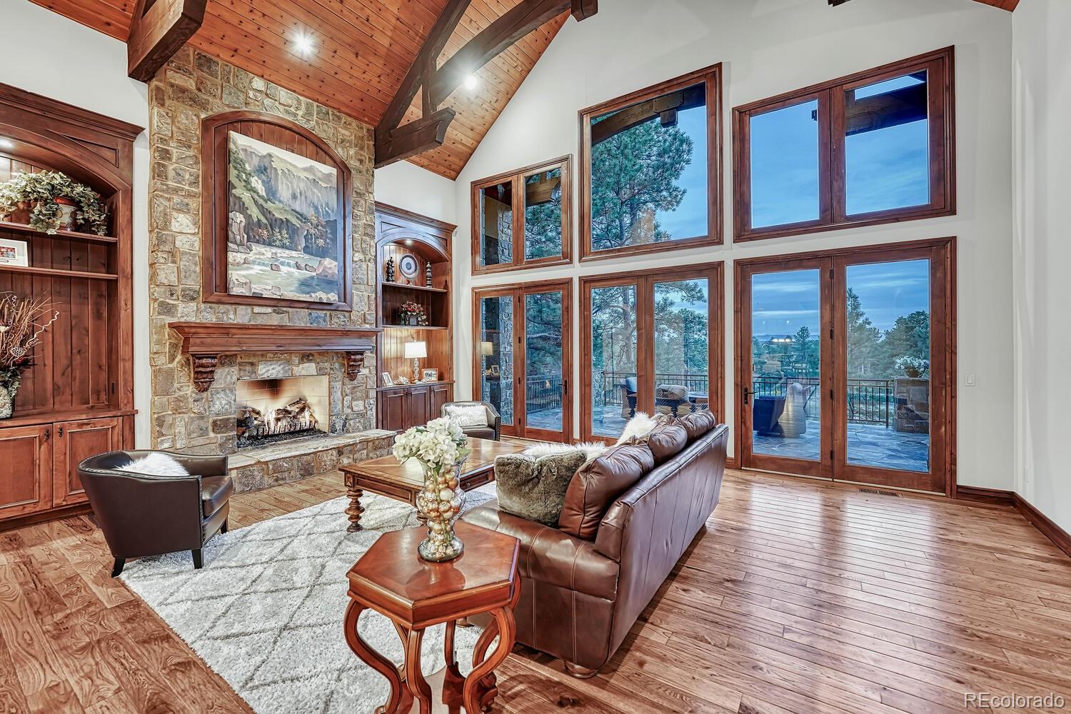 7959 Forest Keep Circle Parker, CO 80134 - Photo 16 of 40 a living room with fireplace furniture and a large window