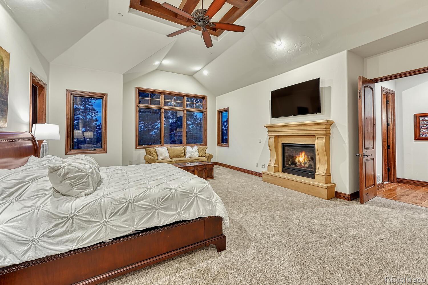 7959 Forest Keep Circle Parker, CO 80134 - Photo 18 of 40 a spacious bedroom with a bed and a flat screen tv