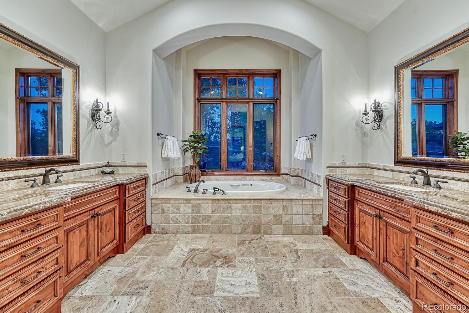 7959 Forest Keep Circle Parker, CO 80134 - Photo 19 of 40 a spacious bathroom with a granite countertop double vanity sink a bathtub and mirror