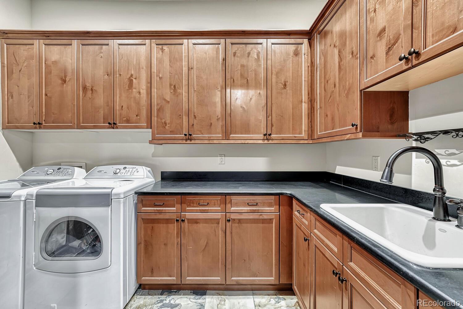7959 Forest Keep Circle Parker, CO 80134 - Photo 20 of 40 a utility room with sink dryer and washer