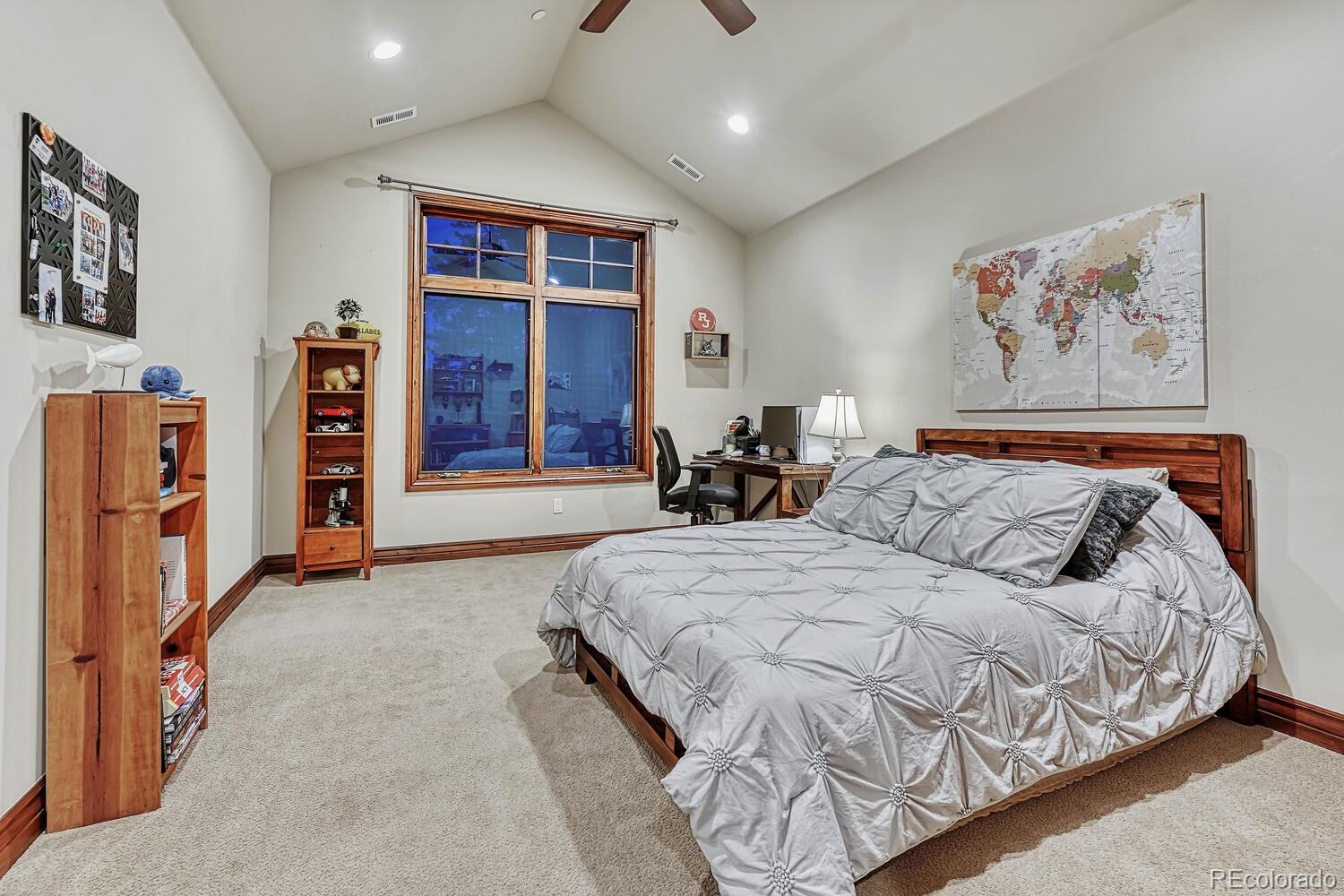 7959 Forest Keep Circle Parker, CO 80134 - Photo 22 of 40 a spacious bedroom with a bed and a walk in closet