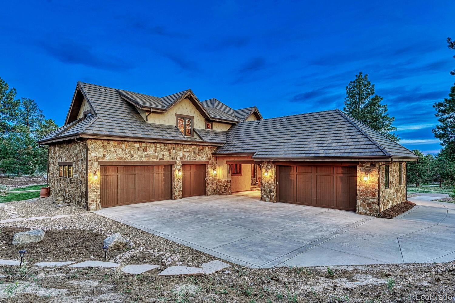 7959 Forest Keep Circle Parker, CO 80134 - Photo 3 of 40 a front view of a house with a yard and garage
