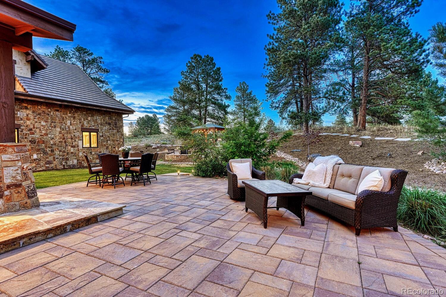7959 Forest Keep Circle Parker, CO 80134 - Photo 32 of 40 a view of a patio with table and chairs and potted plants