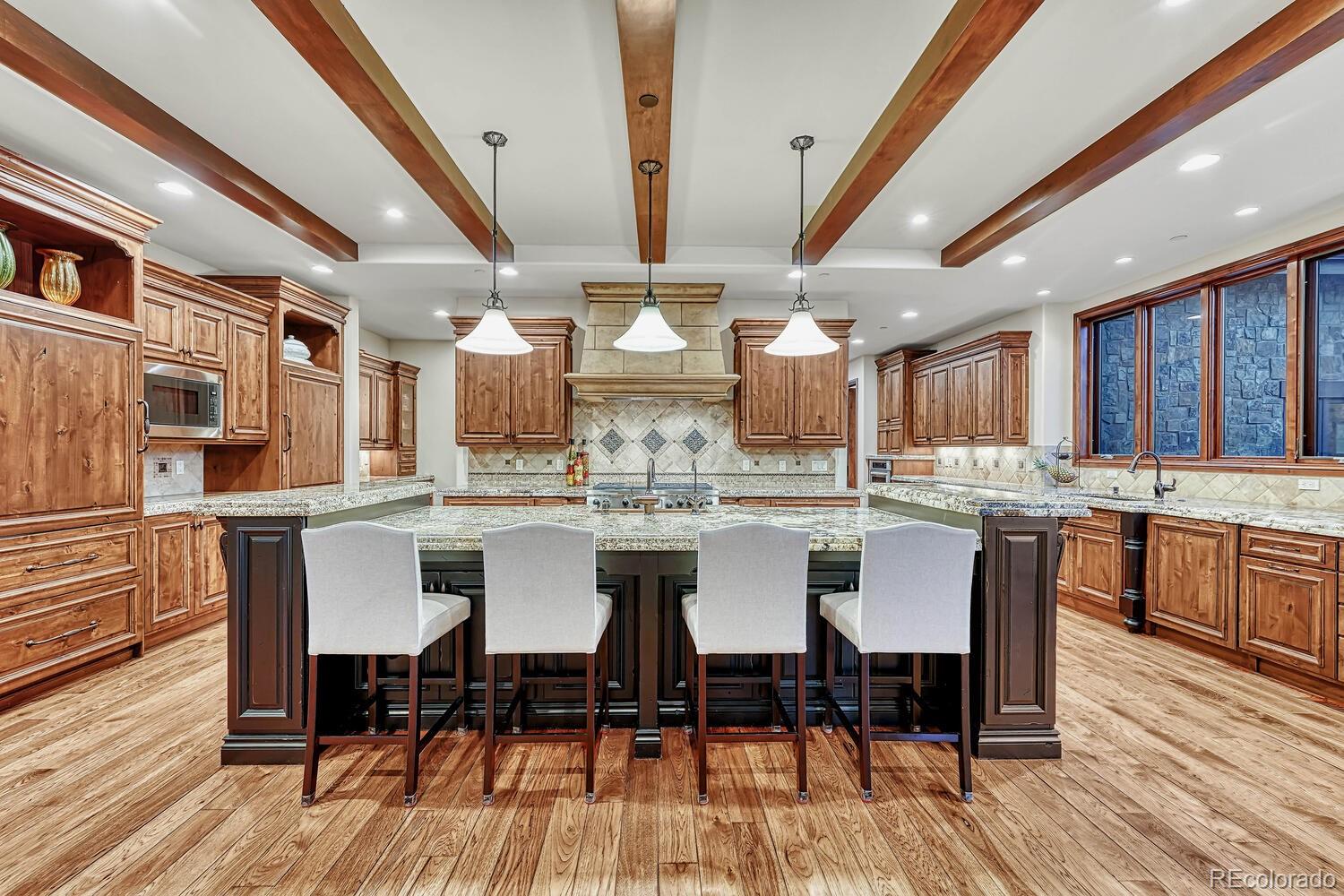 7959 Forest Keep Circle Parker, CO 80134 - Photo 9 of 40 a large kitchen with a table and chairs