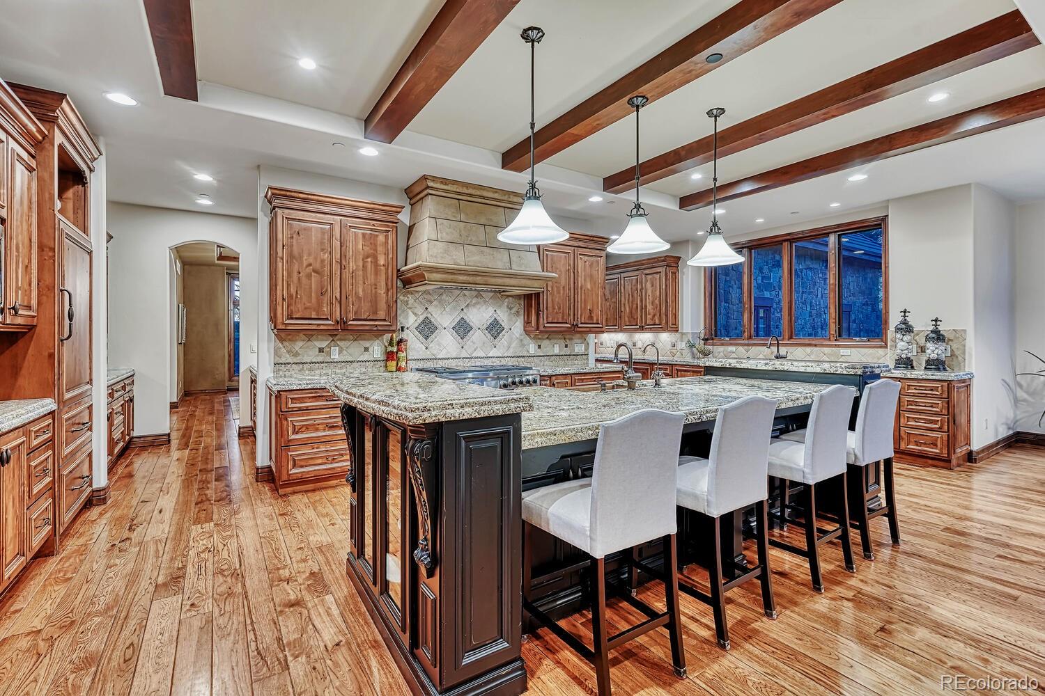 7959 Forest Keep Circle Parker, CO 80134 - Photo 10 of 40 a kitchen with stainless steel appliances granite countertop a kitchen island hardwood floor and a sink