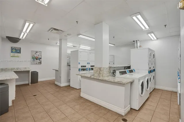 a kitchen with a sink and chairs