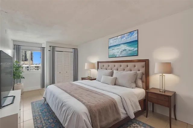 a bedroom with a bed and a lamp