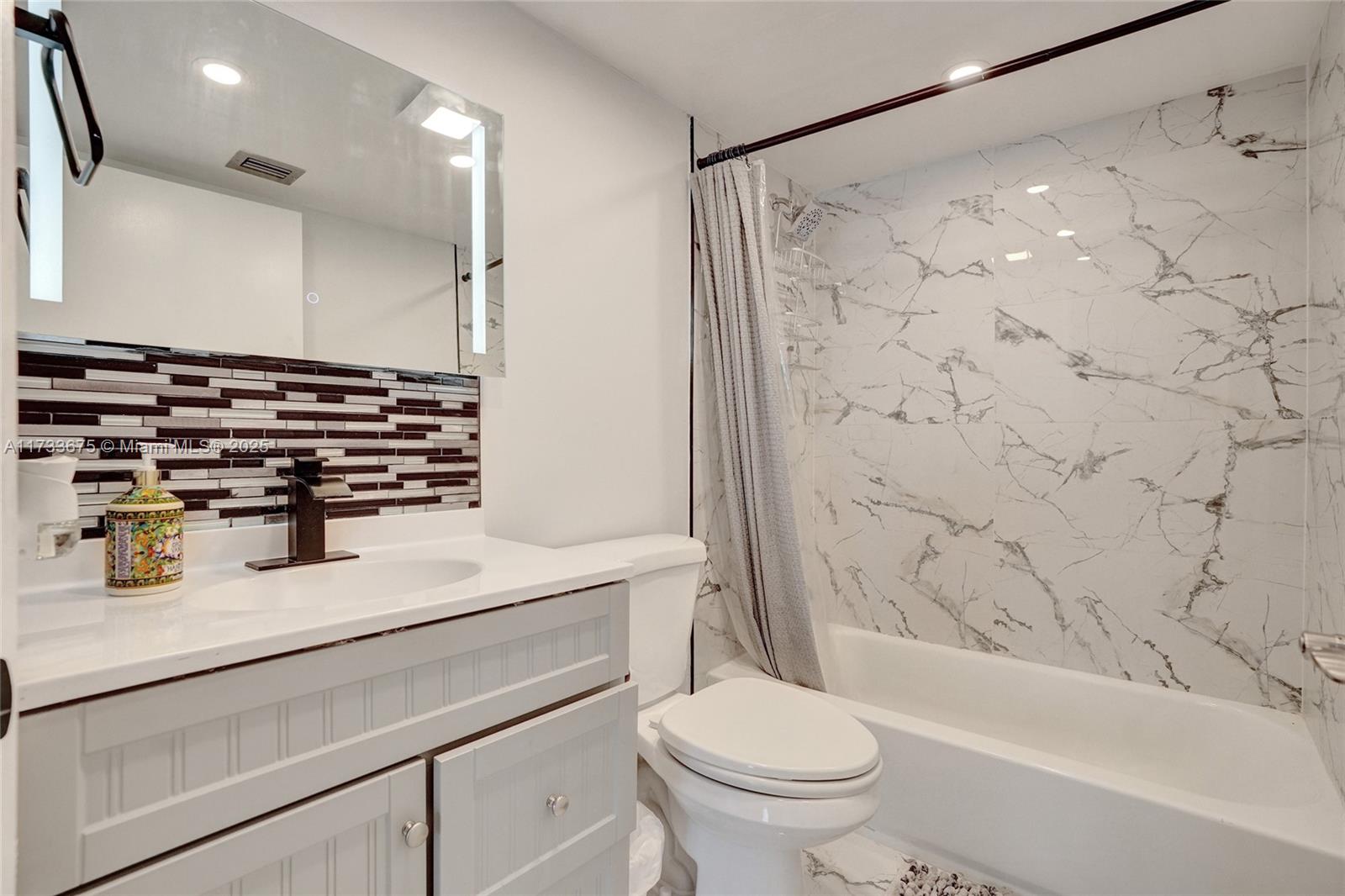 850 North Miami Avenue, Unit W1810 Miami, FL 33136 - Photo 5 of 31 a bathroom with a sink toilet vanity and shower