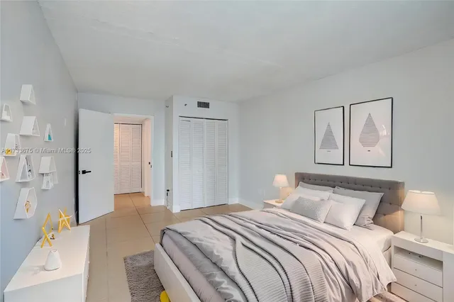 a bedroom with a bed and a painting on the wall