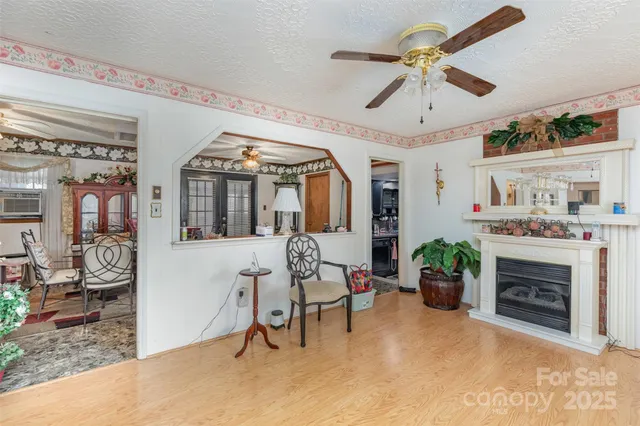 a living room with furniture a chandelier and a fireplace