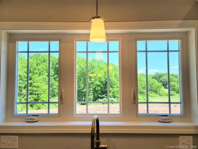 a bathroom with a large window and a bathtub