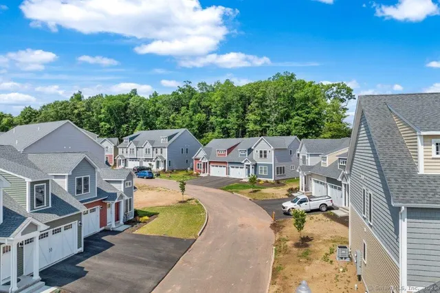 an aerial view of residential houses with outdoor space