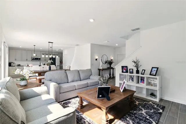 a living room with furniture and a book shelf