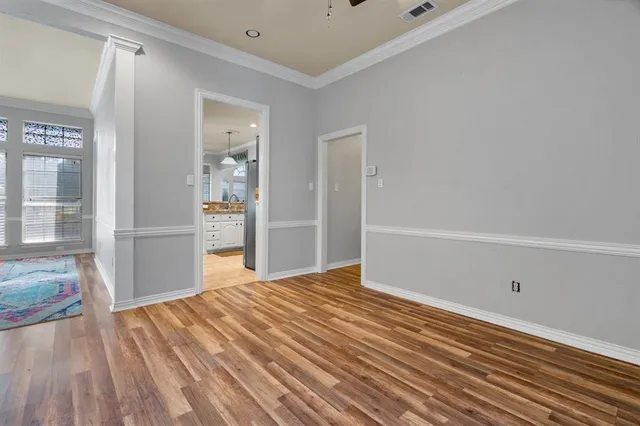 a view of an empty room with closet and a window