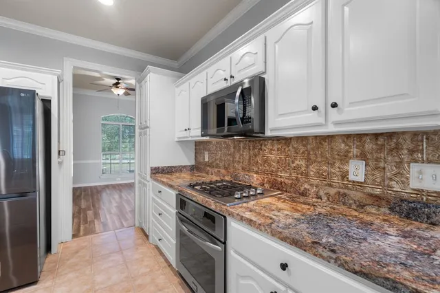 a kitchen with stainless steel appliances granite countertop a stove and a refrigerator
