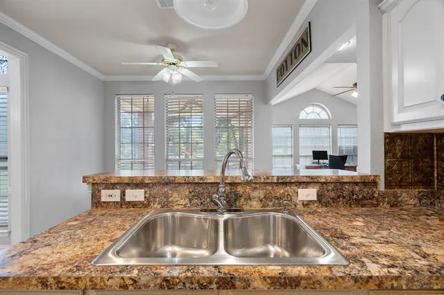 a kitchen with a sink a counter space and a window