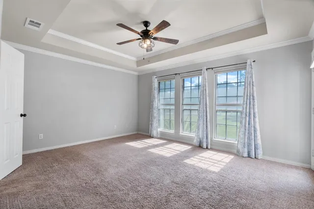 a view of a livingroom with a ceiling fan and window