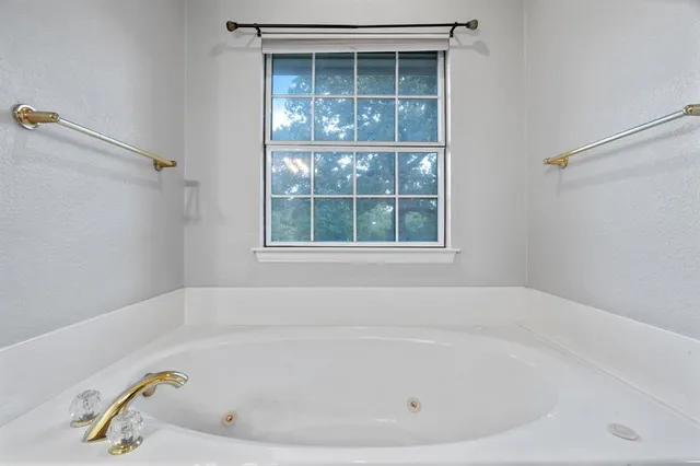 a white bath tub and shower