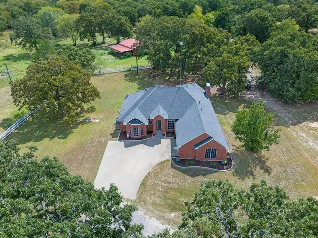 an aerial view of a house with outdoor space and lake view