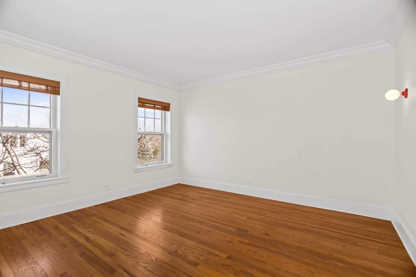 240 Lee Street, Unit 3 Evanston, IL 60202 - Photo 14 of 23 a view of an empty room with wooden floor and a window