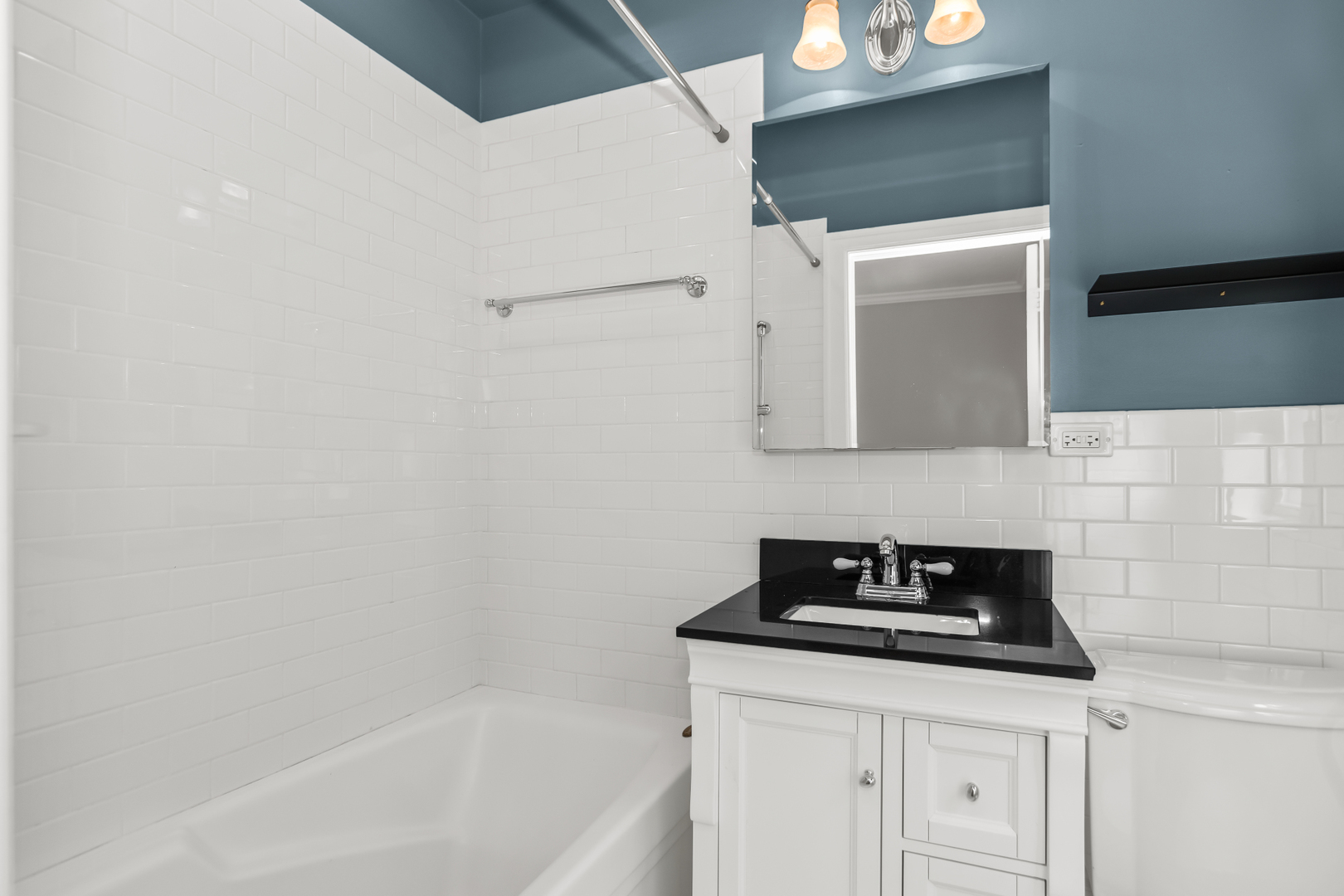 240 Lee Street, Unit 3 Evanston, IL 60202 - Photo 16 of 23 a bathroom with a sink and a mirror