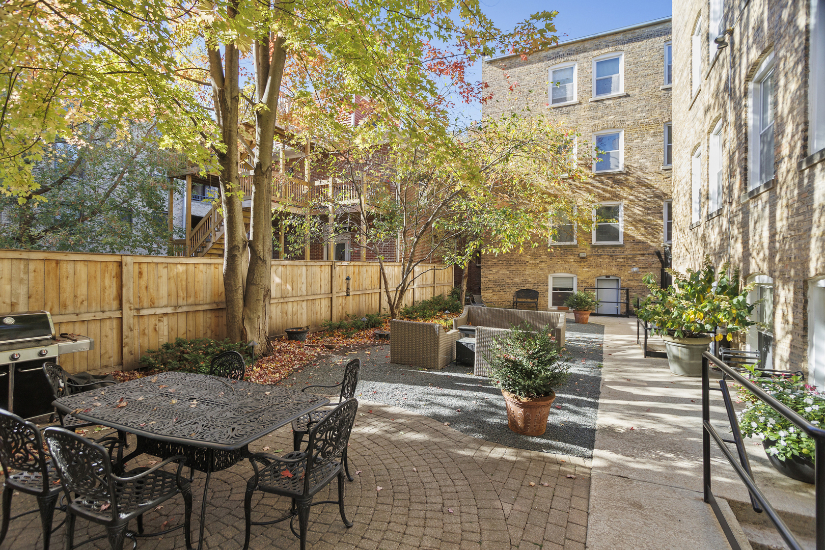 240 Lee Street, Unit 3 Evanston, IL 60202 - Photo 20 of 23 a view of a patio with table and chairs with wooden fence and plants