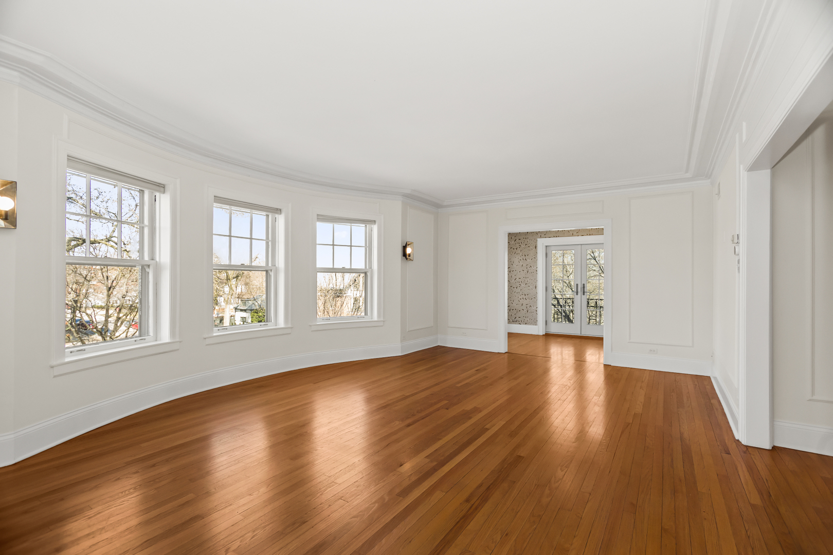 240 Lee Street, Unit 3 Evanston, IL 60202 - Photo 3 of 23 a view of an empty room with wooden floor and a window