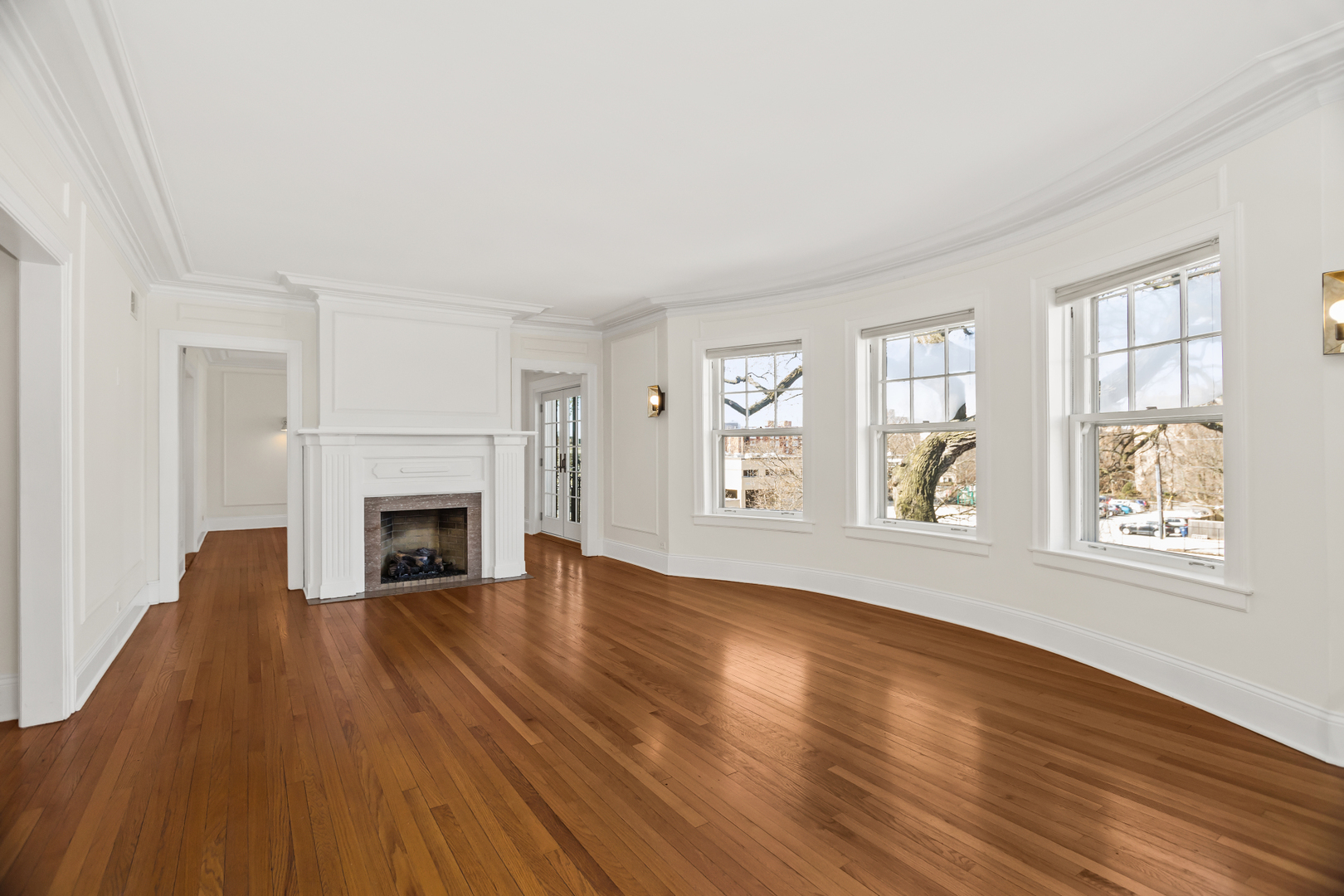 240 Lee Street, Unit 3 Evanston, IL 60202 - Photo 5 of 23 wooden floor fireplace and windows in an empty room