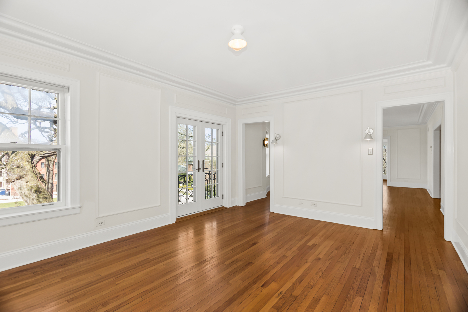 240 Lee Street, Unit 3 Evanston, IL 60202 - Photo 8 of 23 a view of an empty room with wooden floor and a window