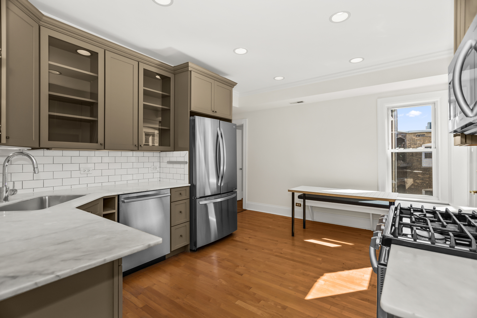 240 Lee Street, Unit 3 Evanston, IL 60202 - Photo 9 of 23 a kitchen with stainless steel appliances granite countertop a refrigerator and a stove top oven