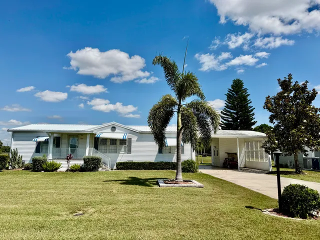 a view of a house with swimming pool and a garden
