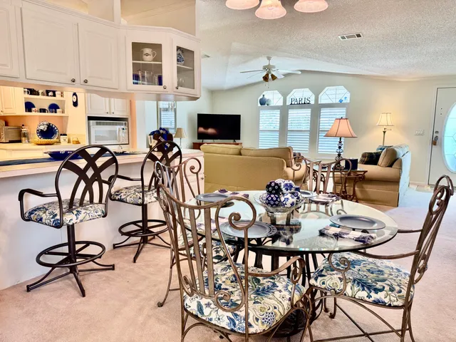 a view of a dining room with furniture chandelier and wooden floor
