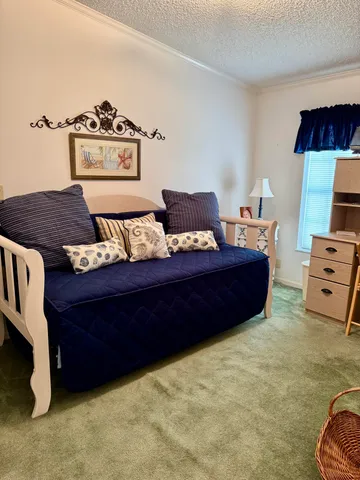 a bed room with furniture and a lamp