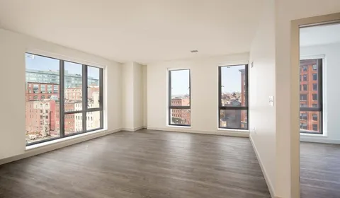 wooden floor in an empty room with windows and wooden floor