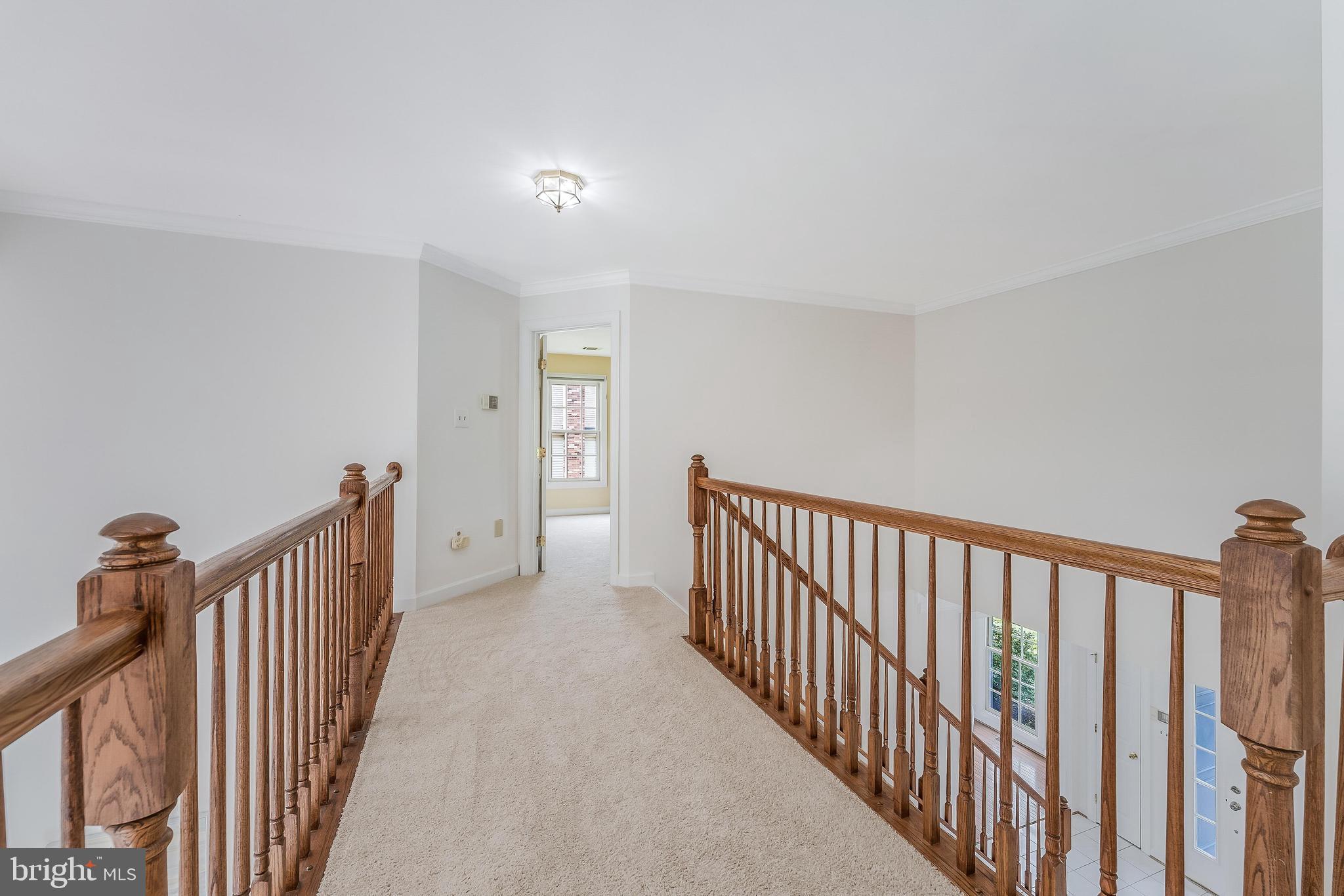 5501 Ashleigh Road Fairfax, VA 22030 - Photo 40 of 77 a view of a hallway with wooden floor and windows