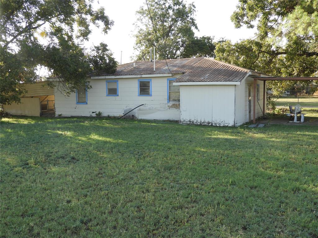 208 Reeves Street Winters, TX 79567 - Photo 8 of 14 a view of a house with a yard