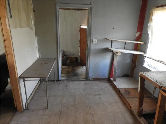 a view of a workspace with furniture and window