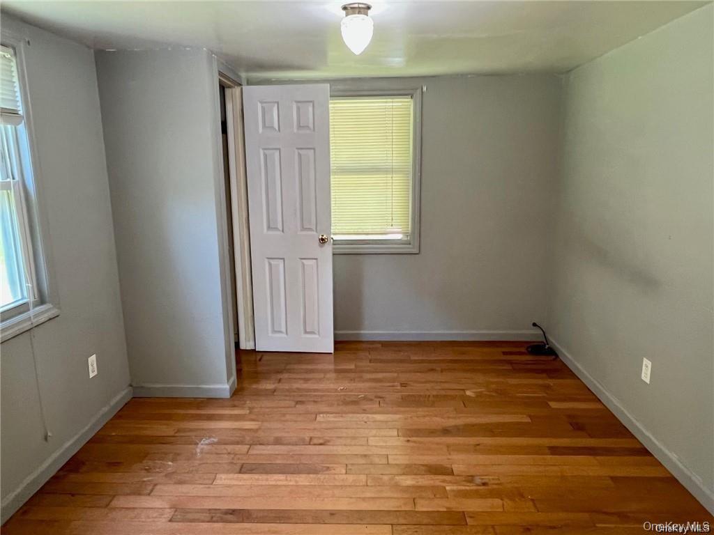 22 Kelly Hill Road, Unit 3 Otisville, NY 10963 - Photo 11 of 16 a view of an empty room with wooden floor and a window