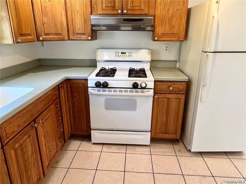22 Kelly Hill Road, Unit 3 Otisville, NY 10963 - Photo 6 of 16 a kitchen with a stove top oven and cabinets