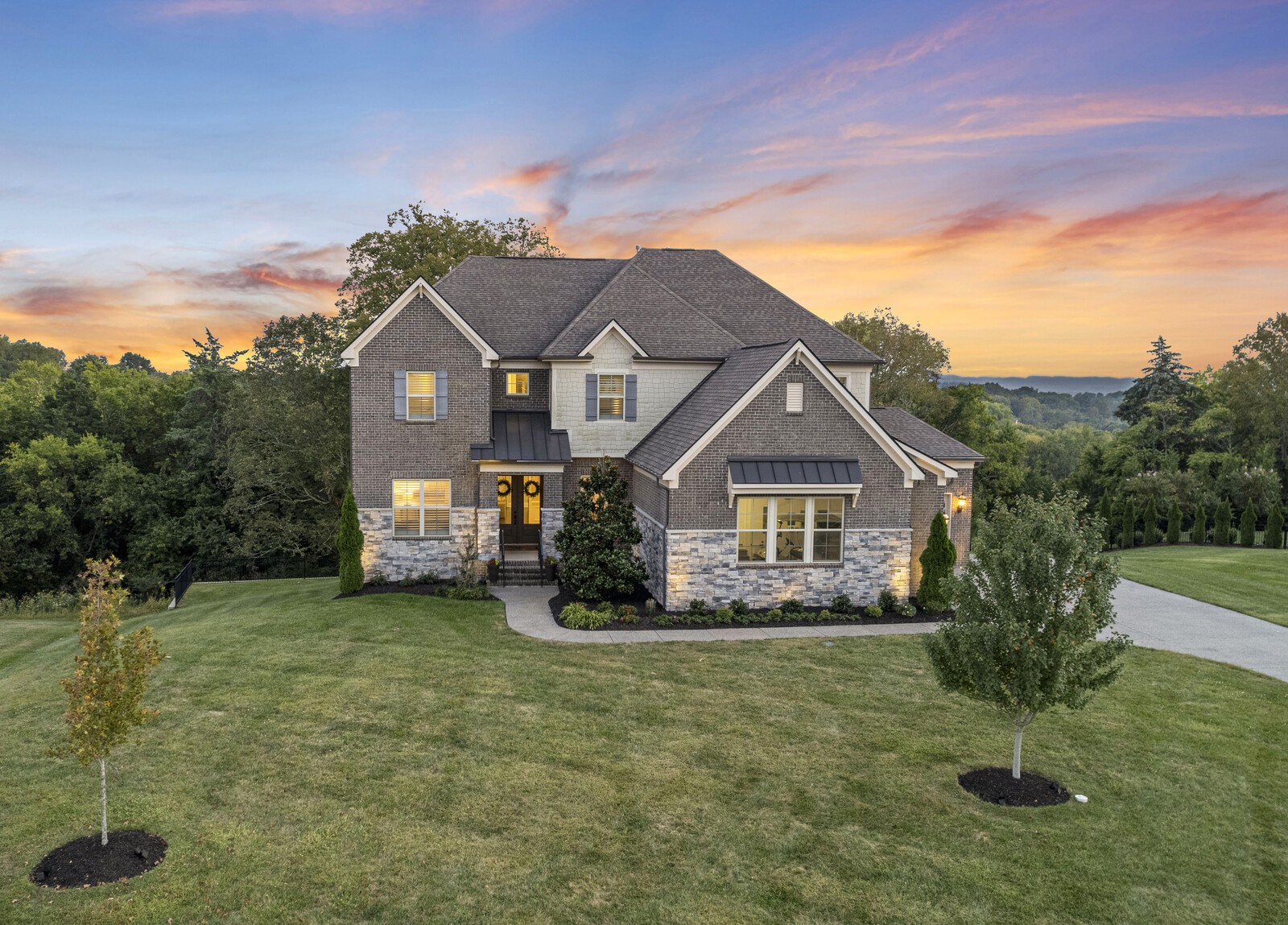 9491 Stillbrook Trace Brentwood, TN 37027 - Photo 1 of 41 a view of a big house with a big yard and potted plants in front of it