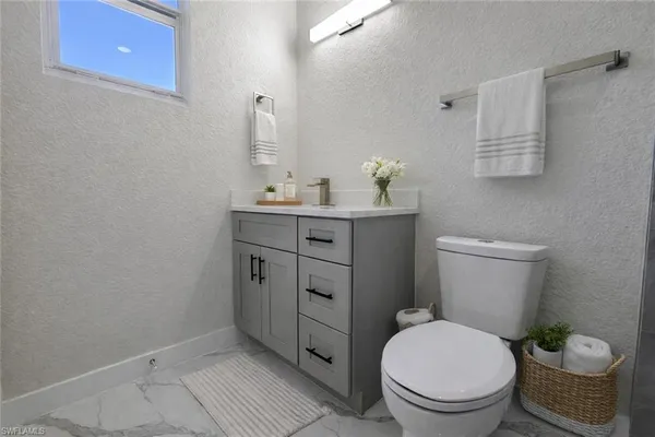 a bathroom with a toilet a sink and shower curtain